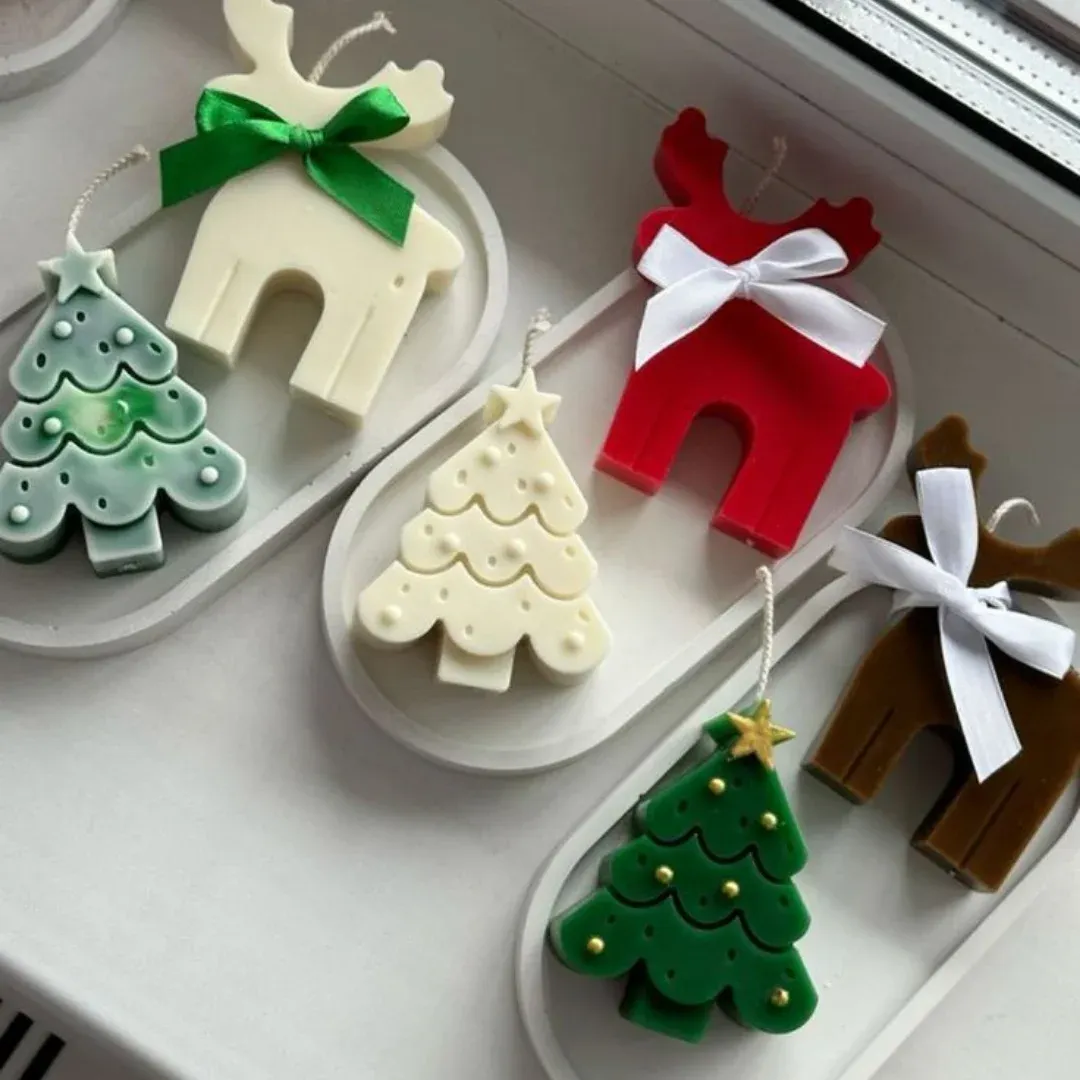Velas navideñas de renos y arbolitos
